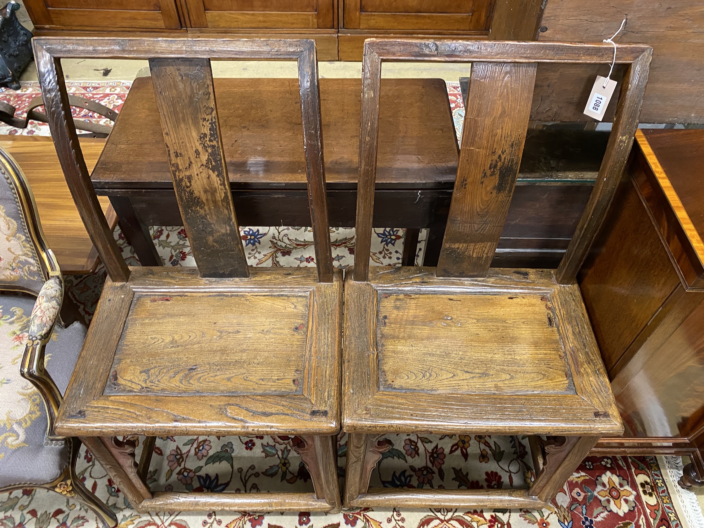 A pair of Chinese elm side chairs, width 54cm, depth 39cm, height 107cm